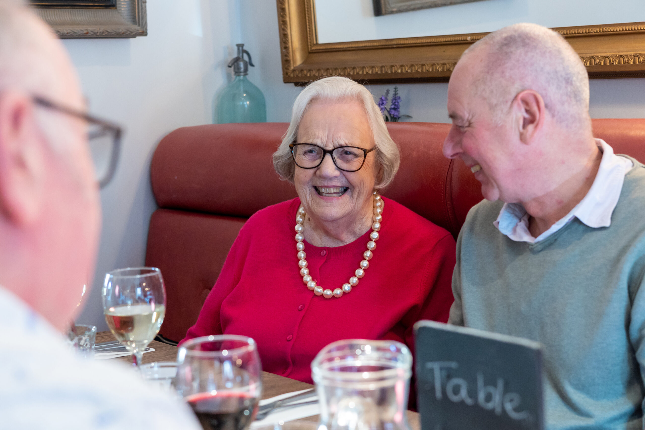 Three people enjoying a chat over lunch