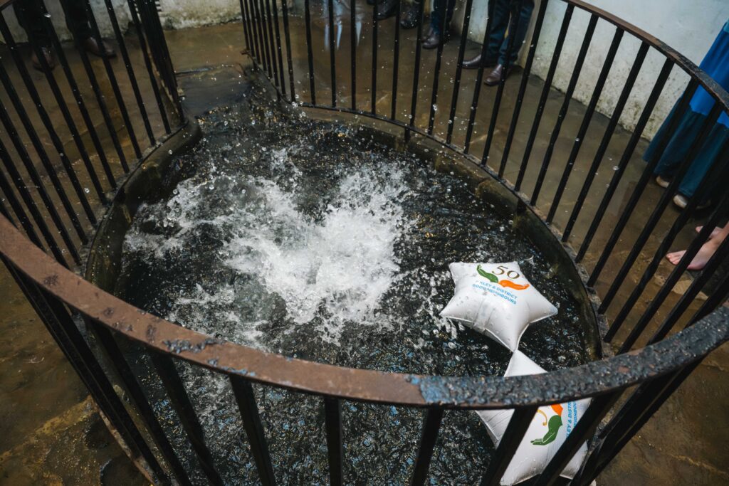 Ilkley White Wells pool splashing water and Ilkley and District Good Neighbours star balloons floating